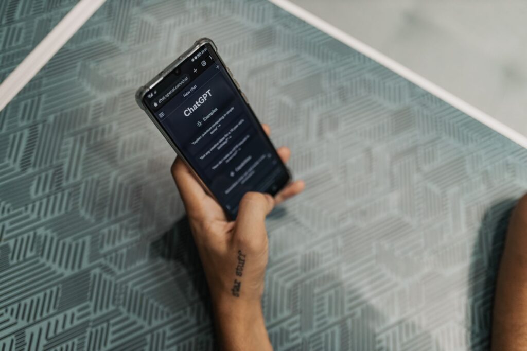 Hands holding a smartphone with a chat app open