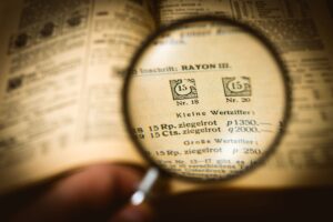 Magnifying glass over the print of an old newspaper